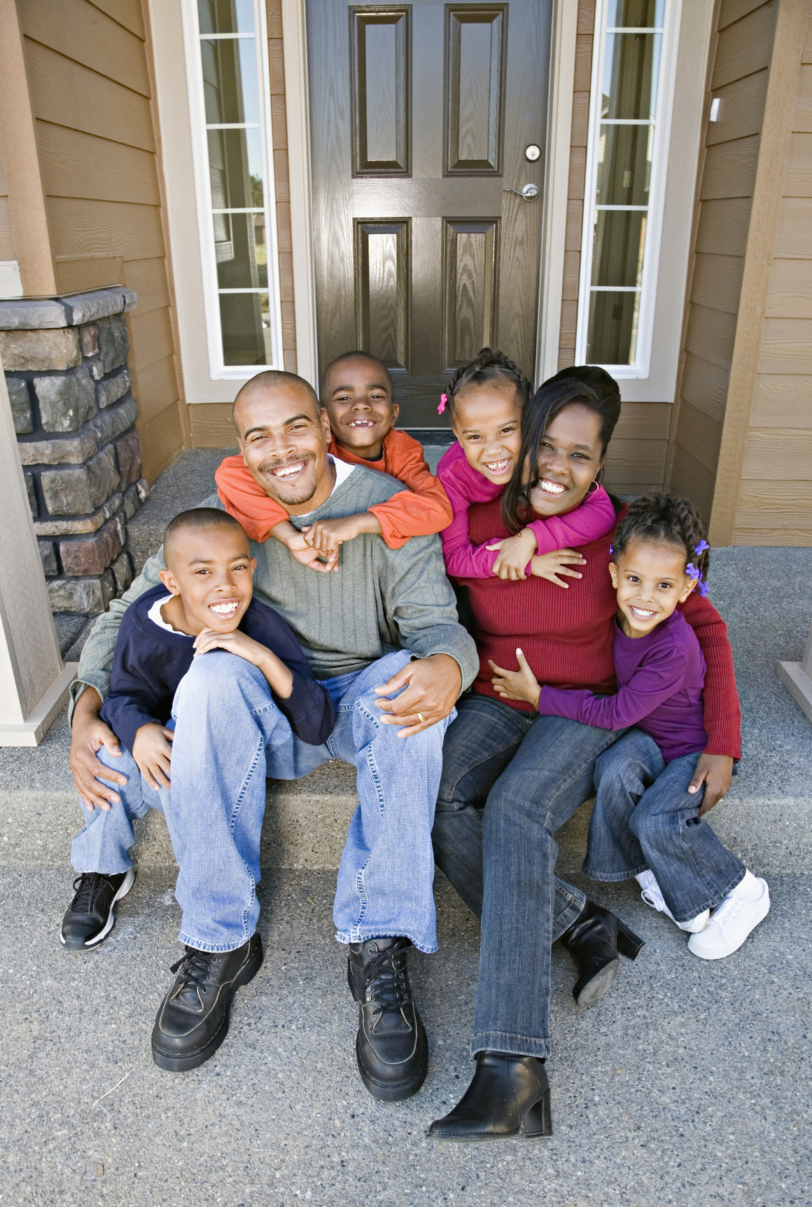 African family sitting on front steps